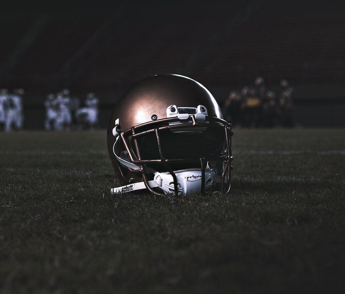 Close-up of helmet in dark stadium