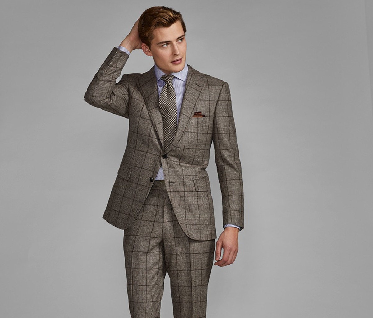 A man wearing a Paul Stuart suit.
