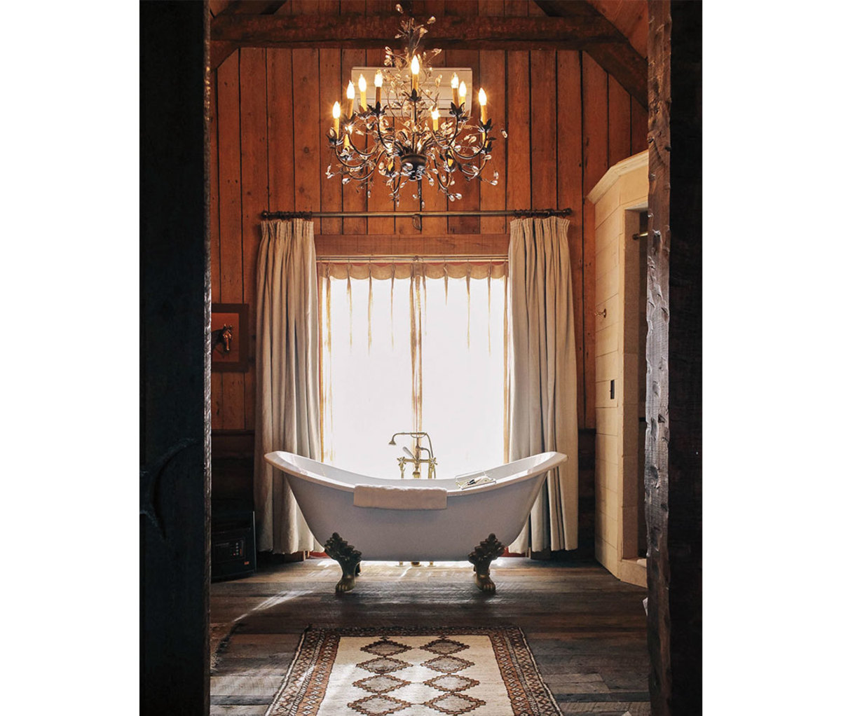 Clawfoot tub with chandelier above