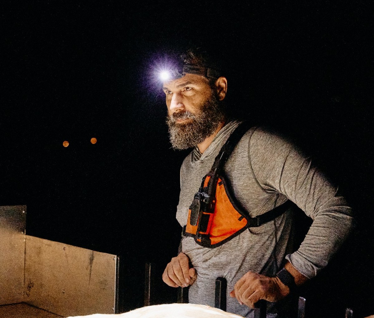 Man with headlamp and vest on