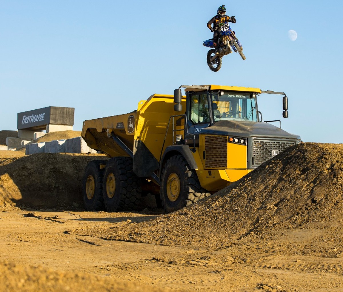 Motocross racer jumping dumptruck