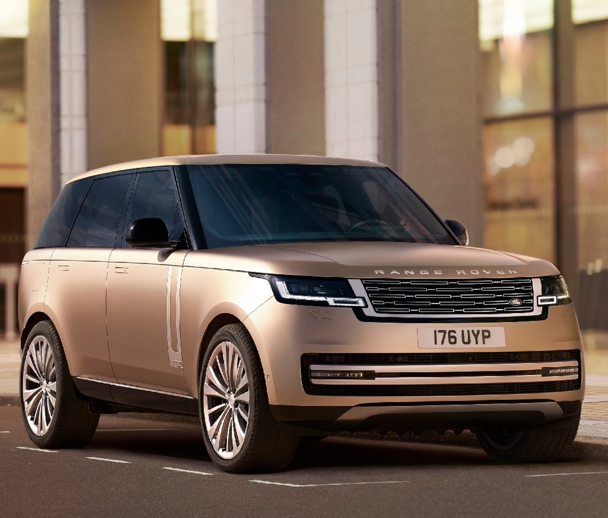 Gold 2022 Range Rover SUV parked on a rendering of a city street