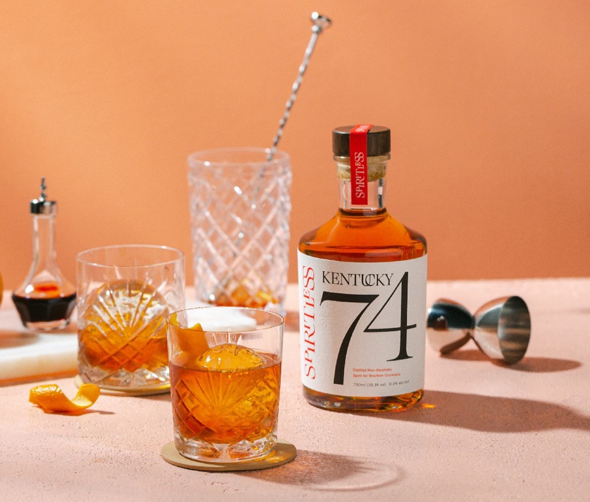 Bottle of Spiritless Kentucky 74 on a table with mixing glass