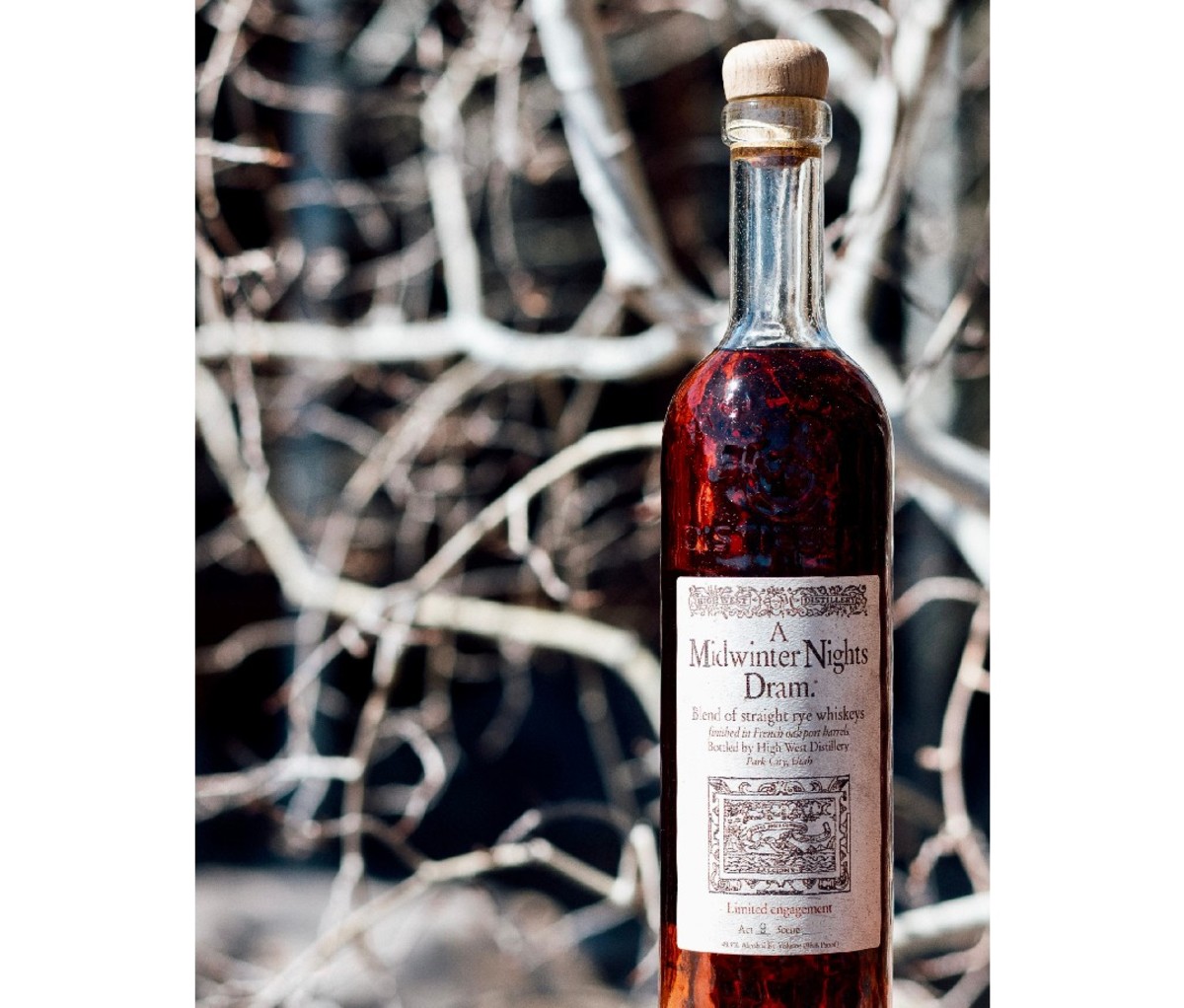 Bottle of High West A Midwinter Night’s Dram Act 9 whiskey with a blurred tree branch background