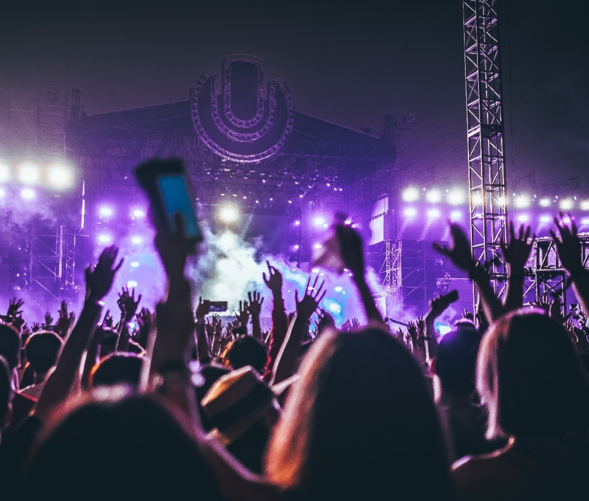 Fans with phones in the air at an indoor music concert