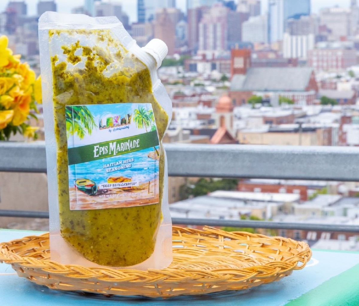 Package of Lakay Epsis marinade on a table with cityscape background