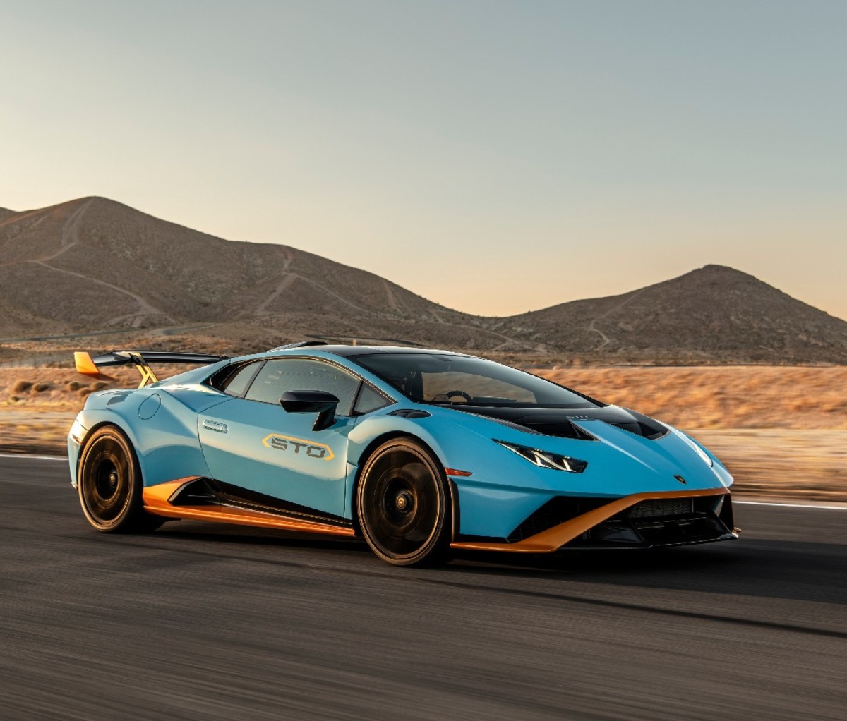 Side profile of blue 2021 Lamborghini Huracán STO on a race track