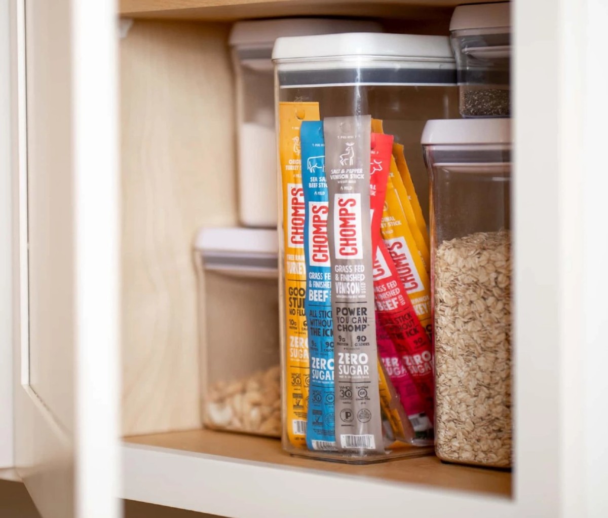 Variety of Chomp meat sticks stored in a pantry