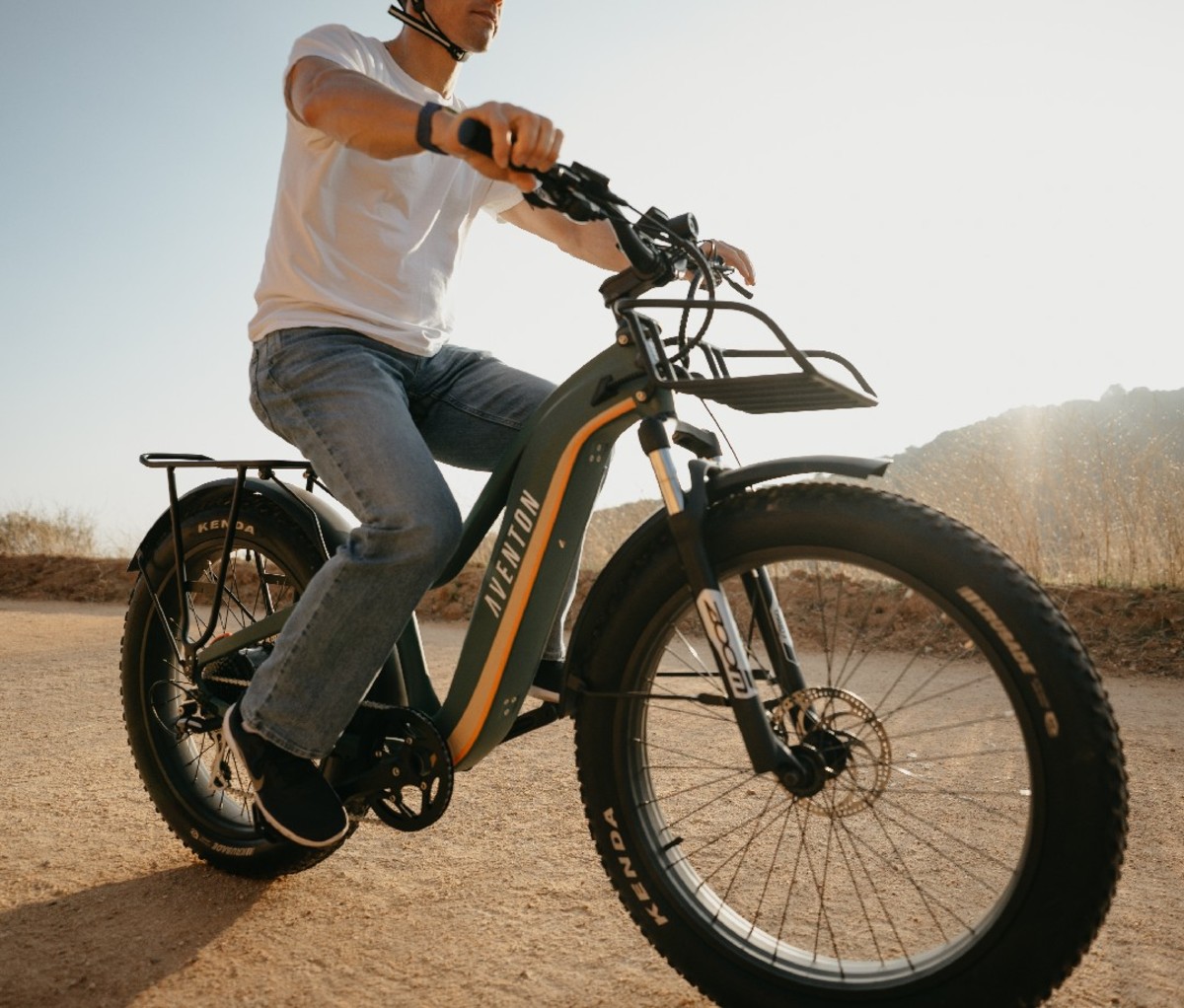 Man riding an Aventon Aventure Ebike on a dirt road