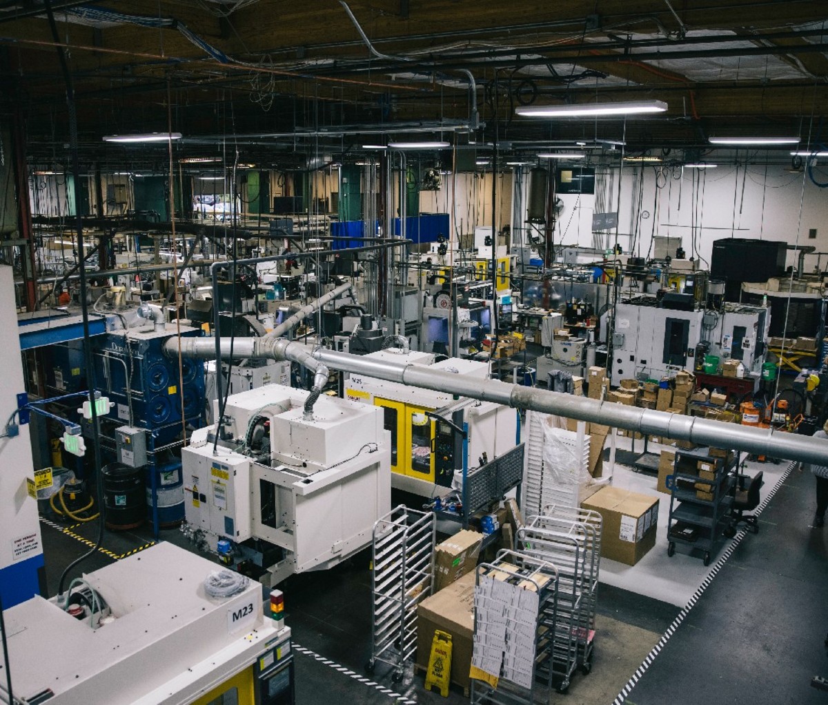 Interior wide shot of the Benchmade factory with rows of machines