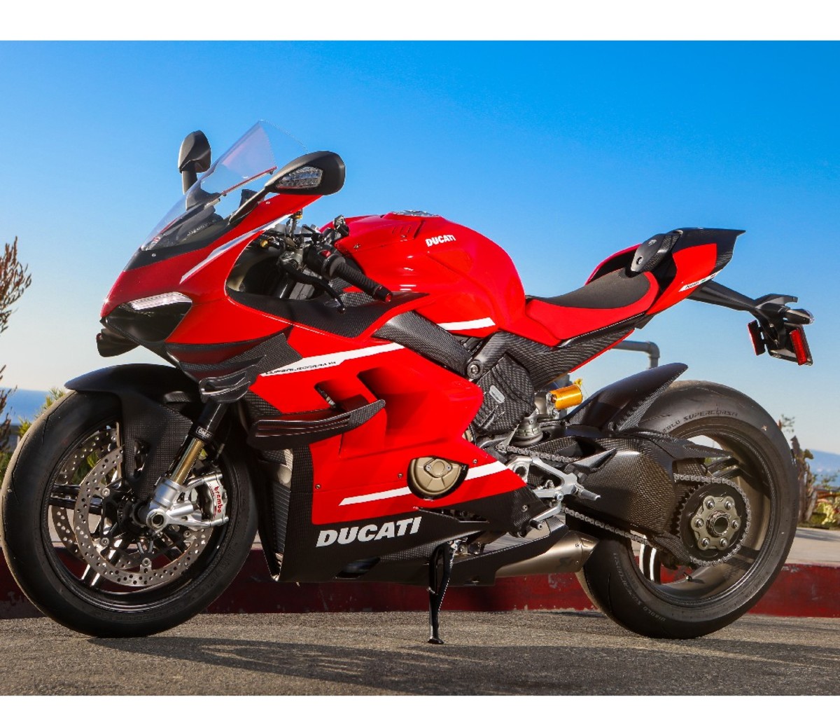 2021 Red Ducati Superleggera V4 motorcycle parked on the road, side image