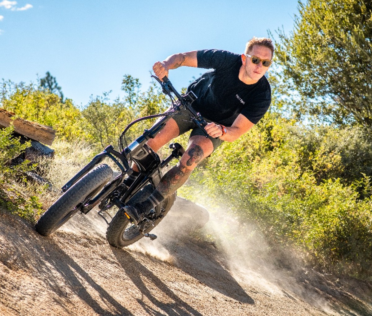 Man riding an Aventon Sinch Foldable Ebike on a dirt trail.