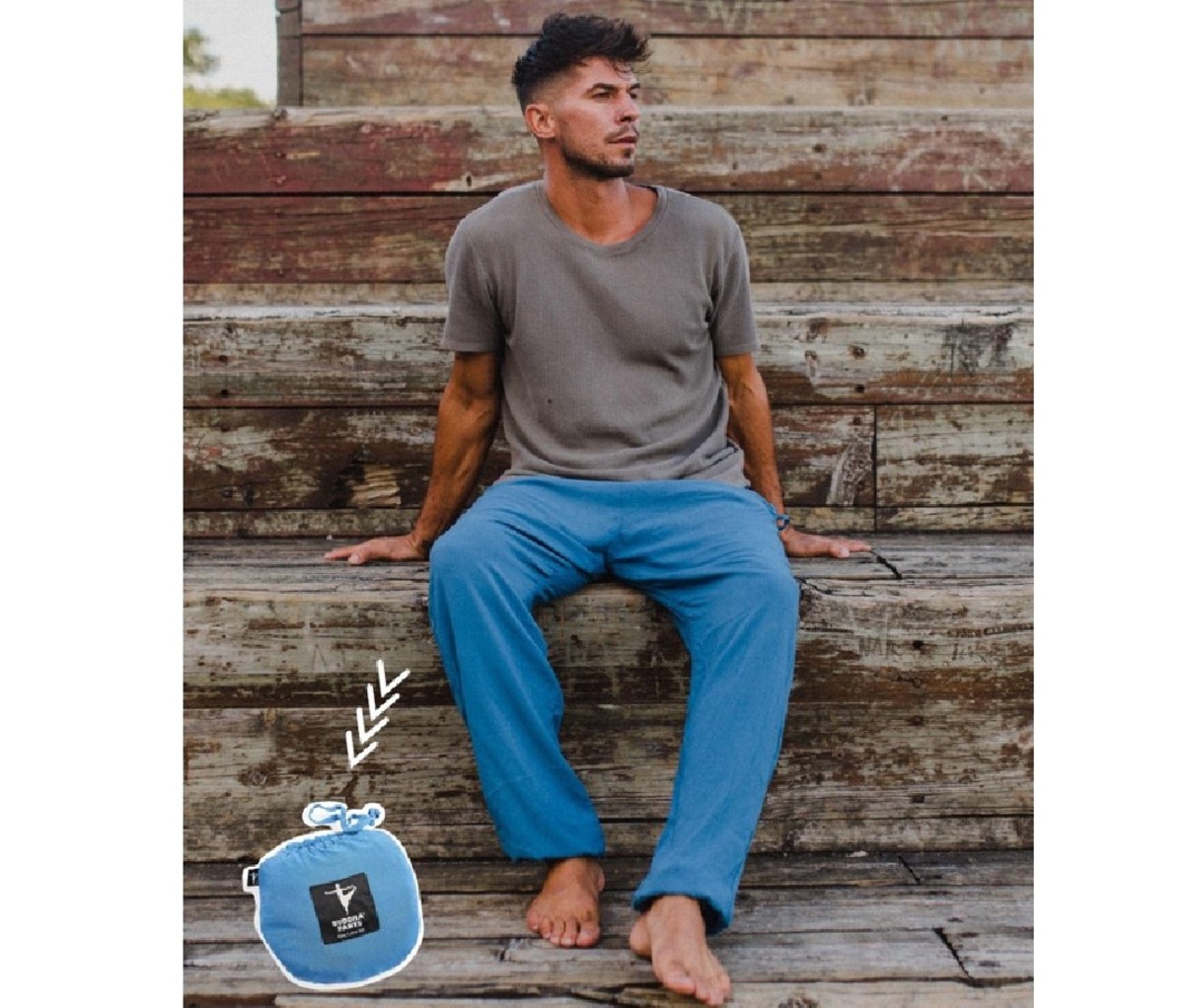 Seated man wearing a pair of blue Buddha Pants