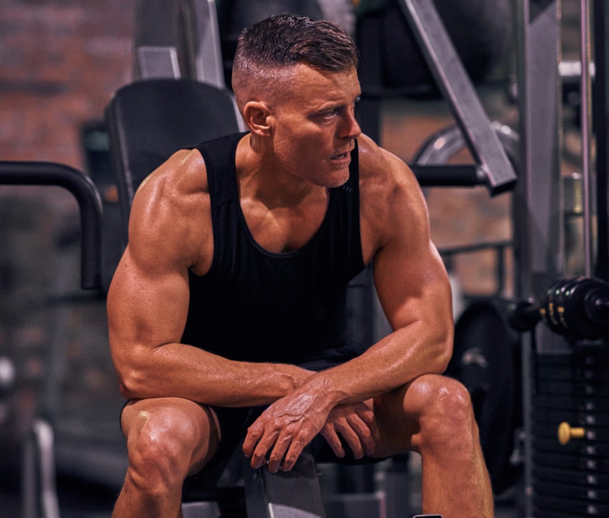 Rawson Thurber sitting on a bench in the gym