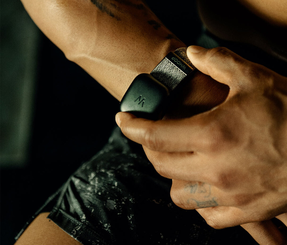 Man putting battery pack on wearable device