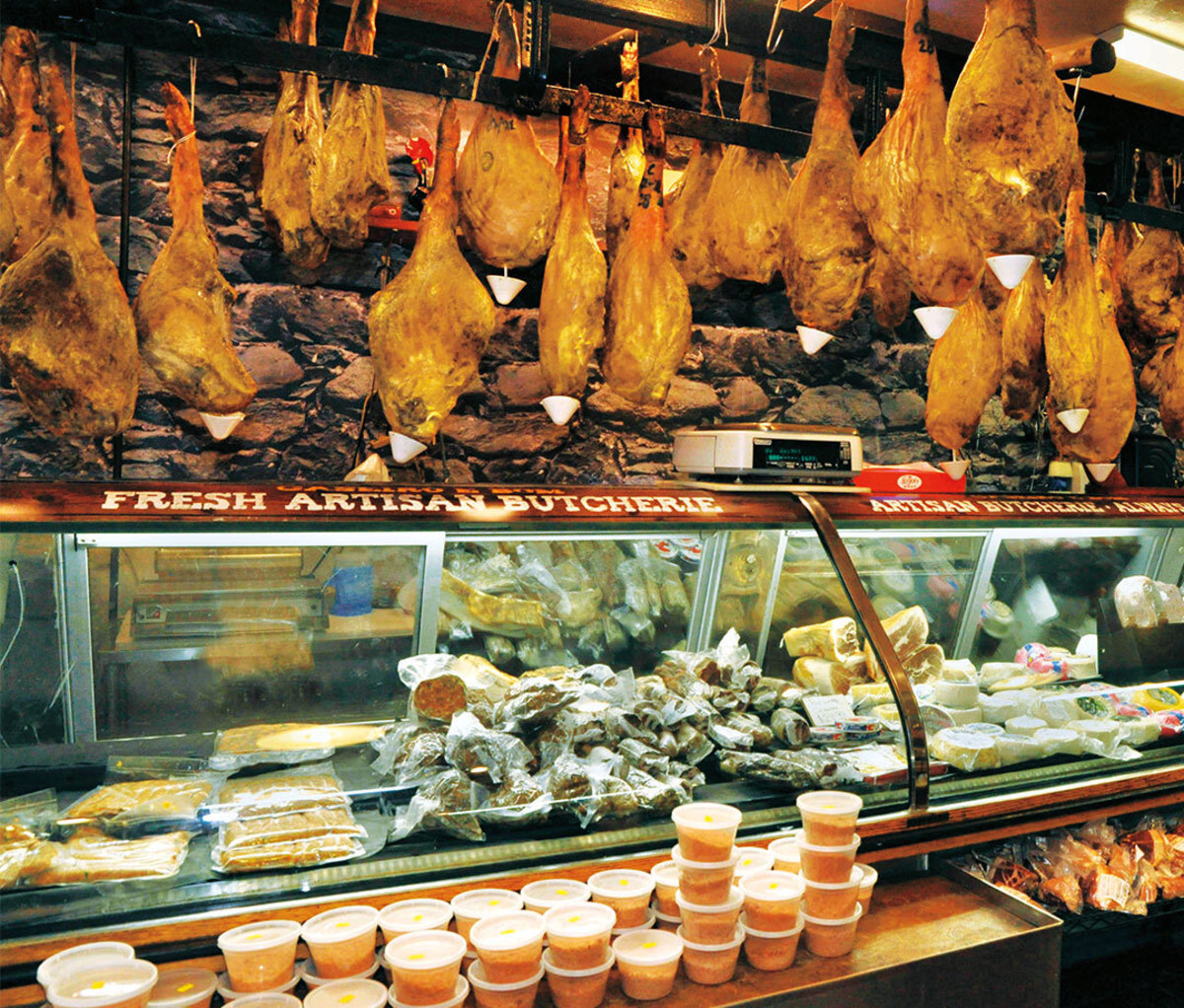 Deli counter with pork aging above it