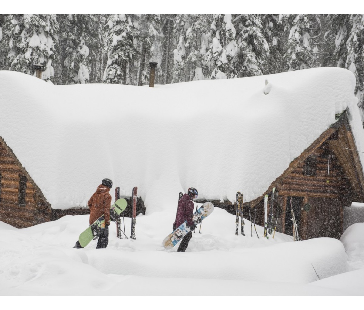 Snowboarders heading to a private cabin at Red Mountain Resort