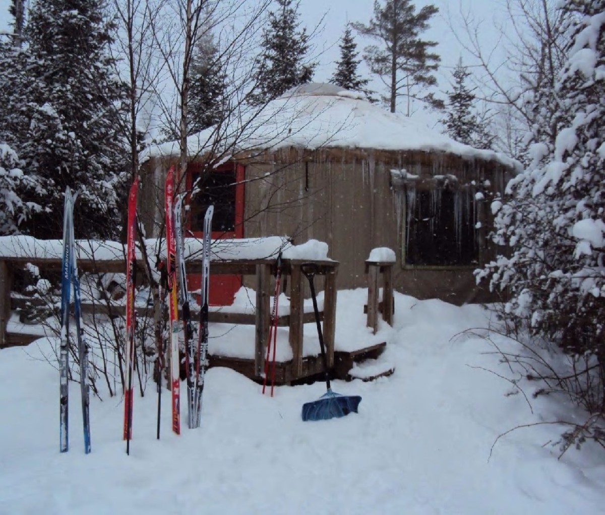 A winter yurt managed by Boundary Country Trekking with skis out front in Minnesota's Superior National Forest