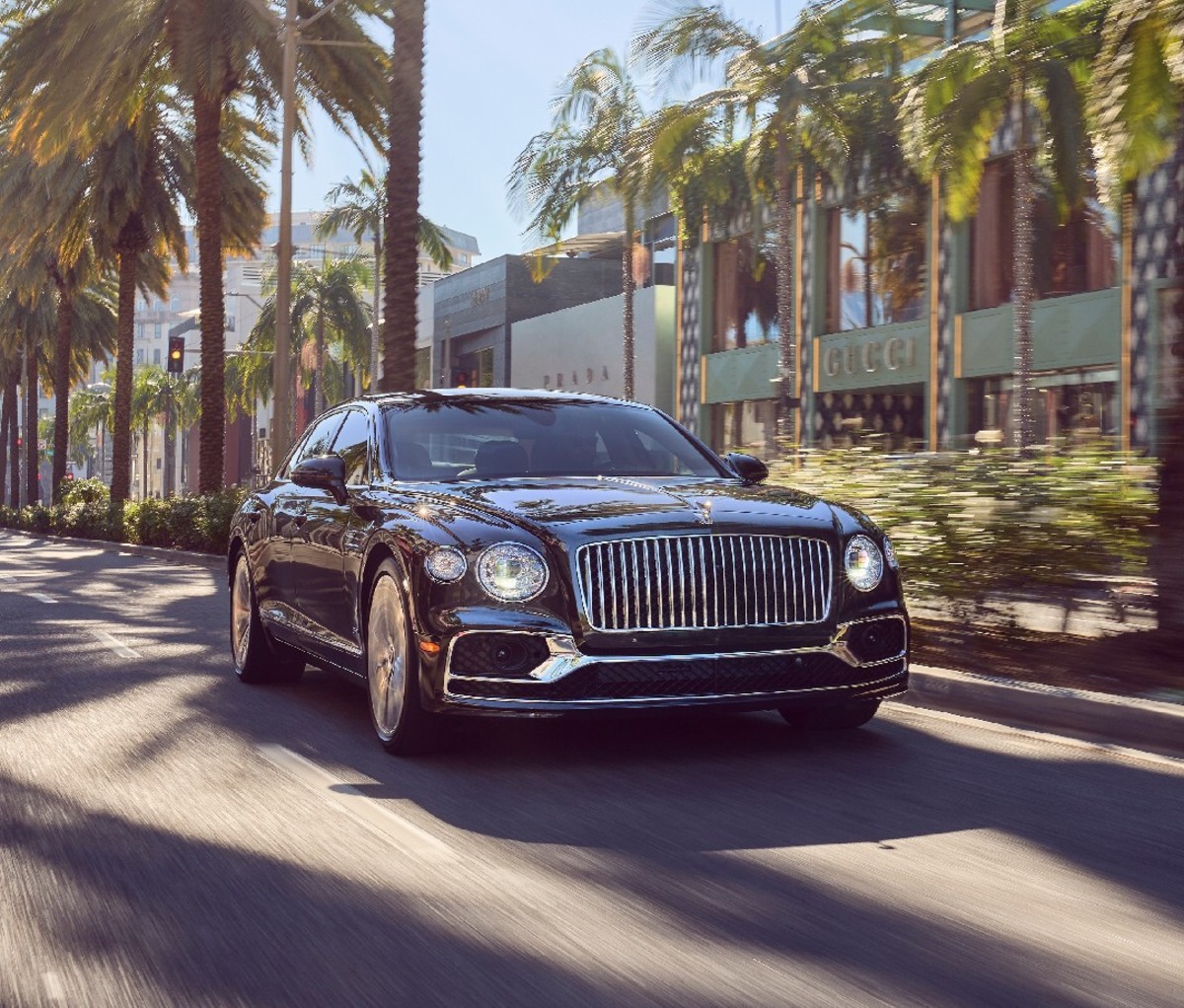 Black 2022 Bentley Flying Spur Hybrid driving through Beverly Hills, CA