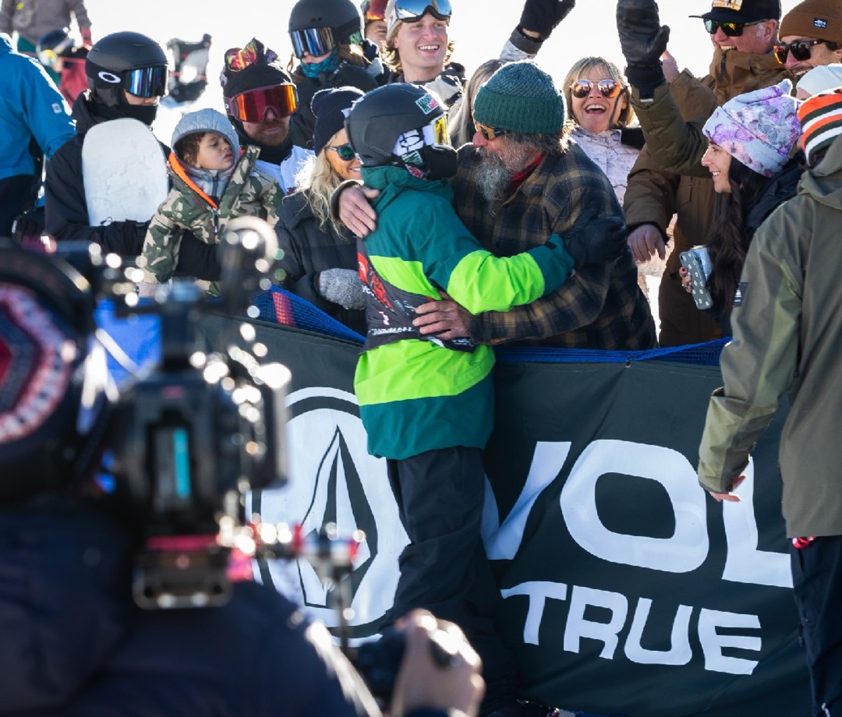 Red Gerard hugged by his father Conrad at the end of his winning run
