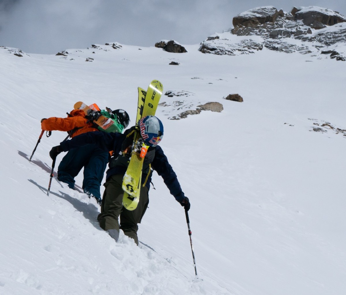 Freeskiers Sam Anthamatten and Jeremie Heitz climbing up a peak in deep snow