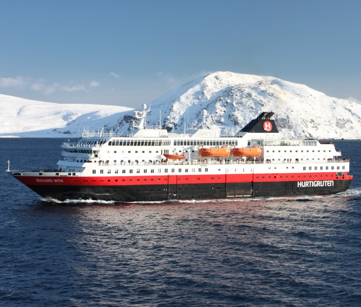 Hurtigruten cruise ship sails along the coast of Northern Norway