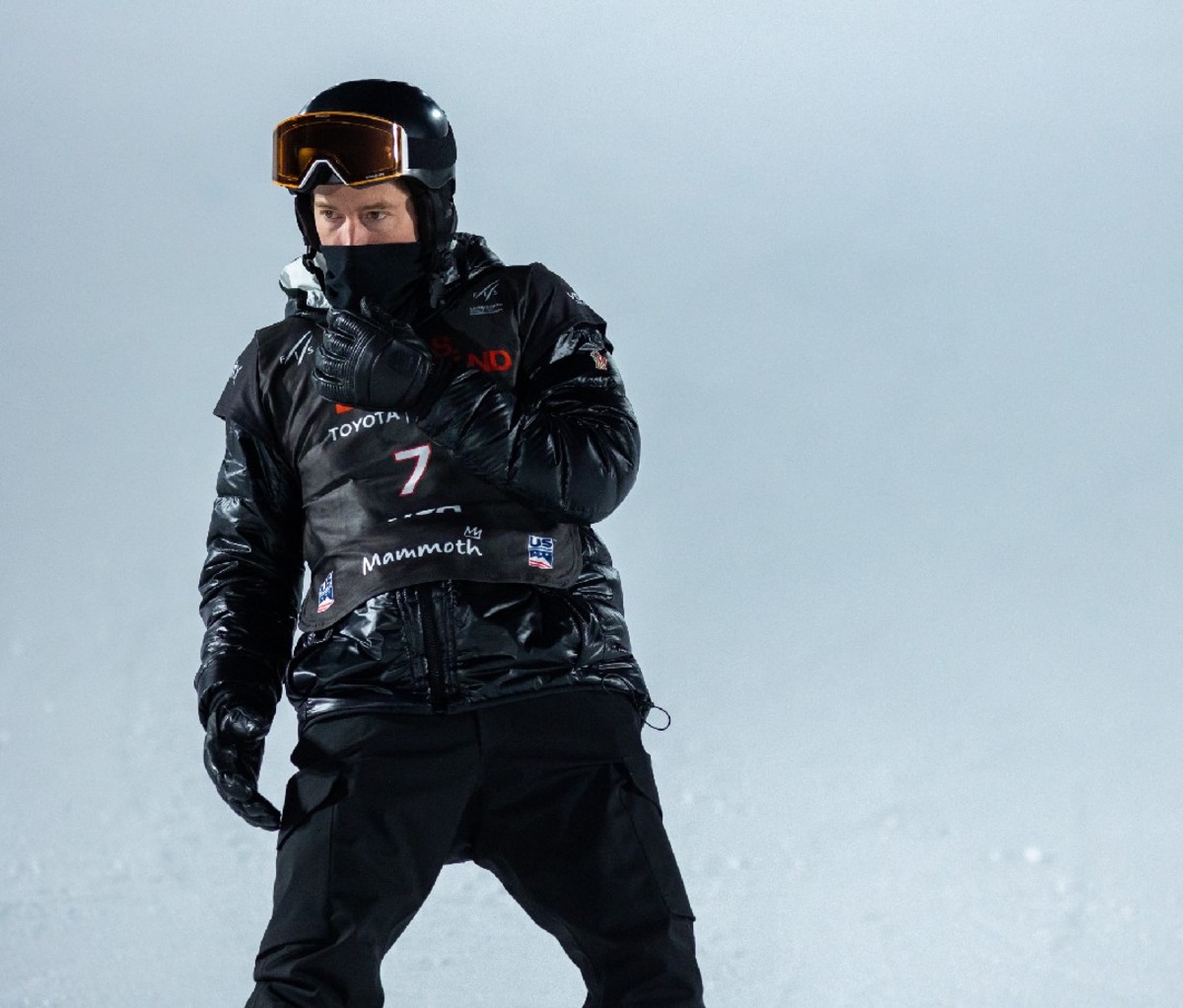 Snowboarder Shaun White stands at the top of the run