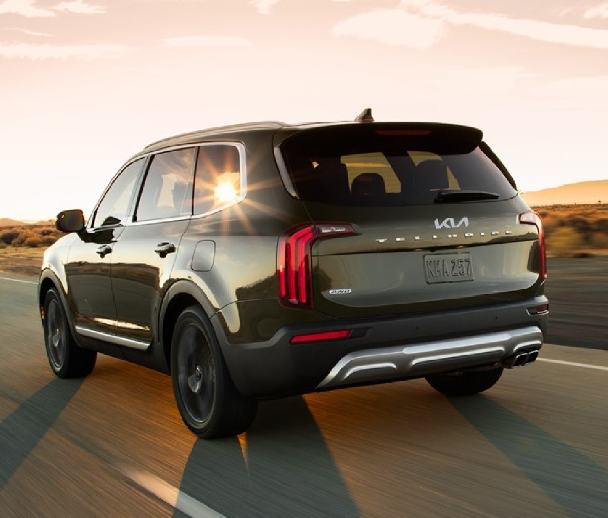 Black 2022 Kia Telluride driving on a road, rear view