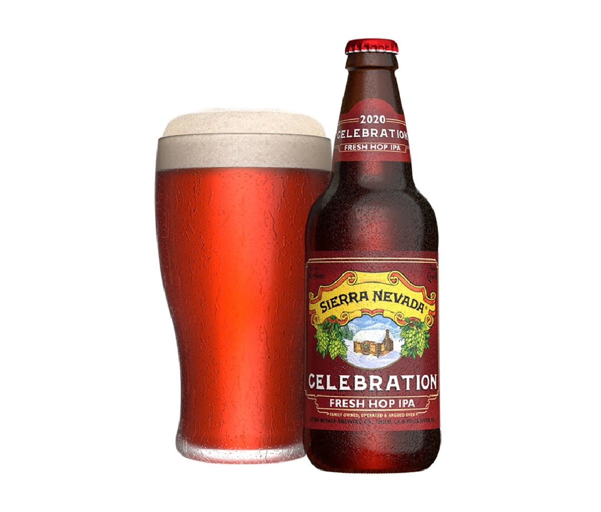 12 oz bottle of Sierra Nevada Celebration beside a full pint glass