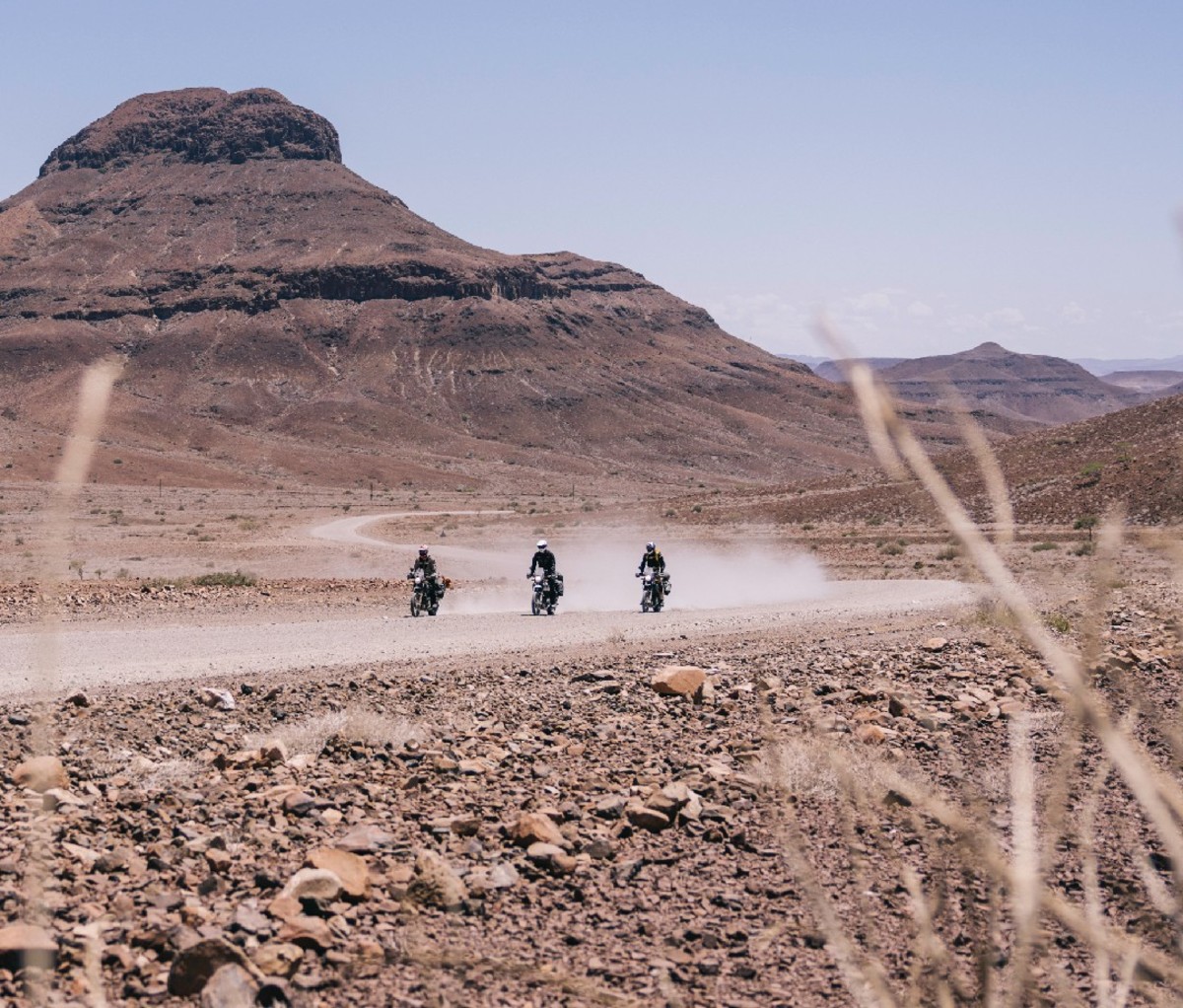 Three motorcycles riding through Africa's Namib desert