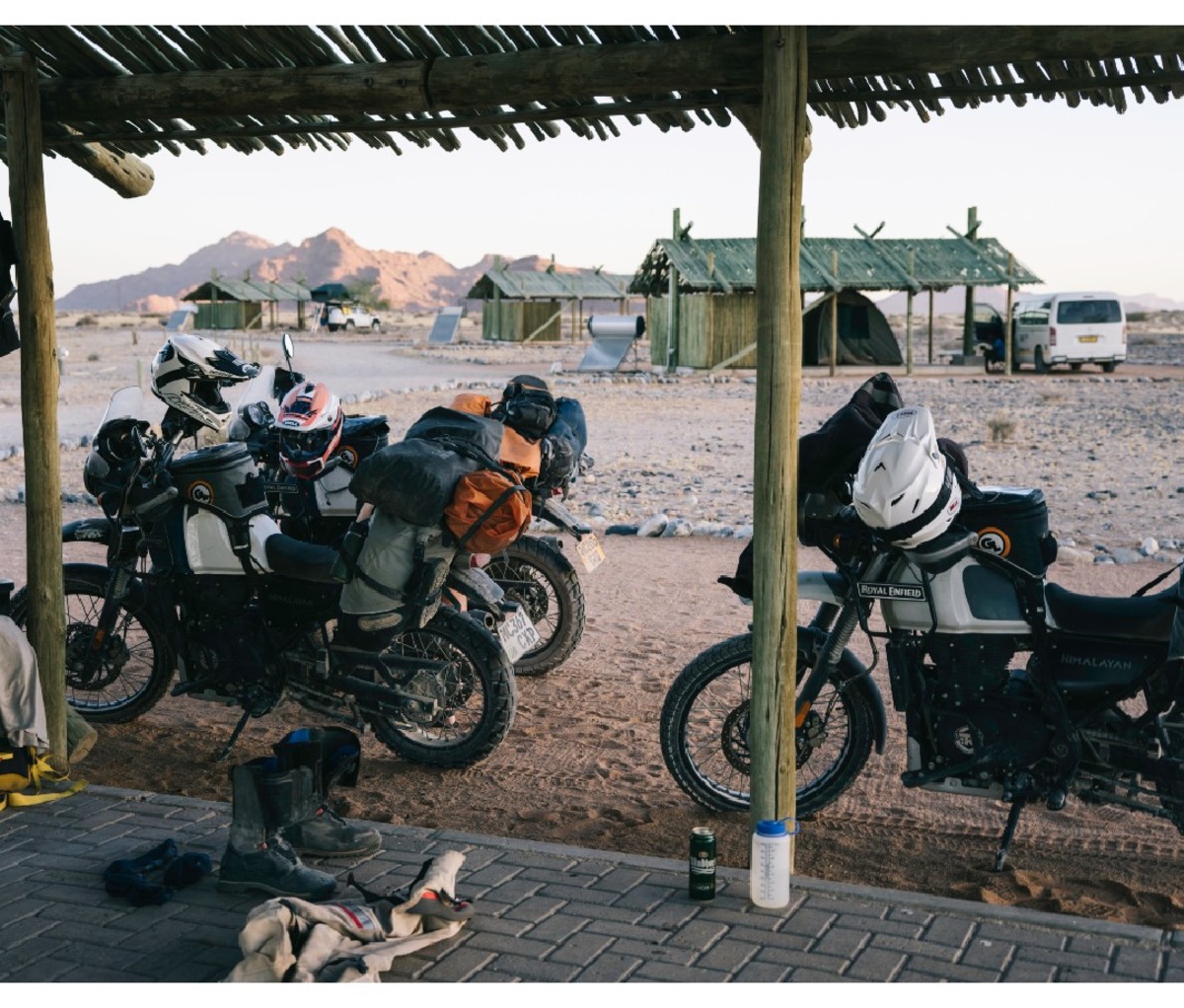 Motorcycles parked beside a hut-like Namib desert dwelling in Africa