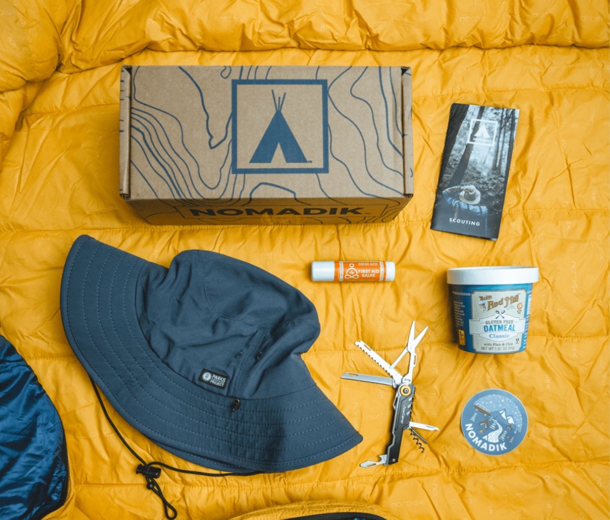 The Nomadik items laid out on a yellow sleeping bag