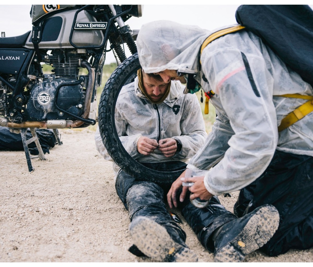 Motorcyclists making repairs on a tire during a road trip through Africa