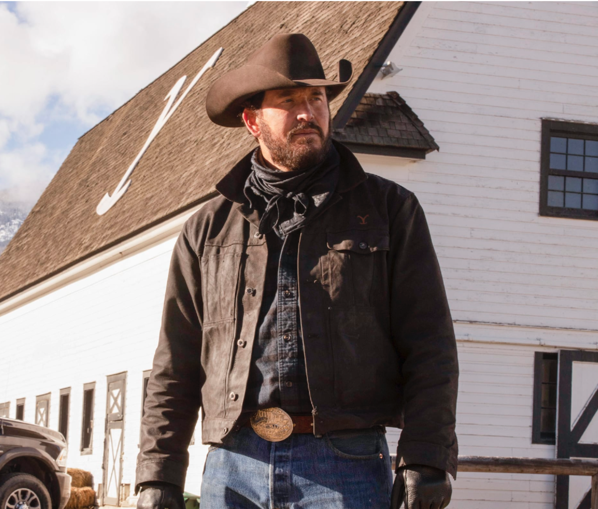 Man wearing cowboy hat, jacket, and belt