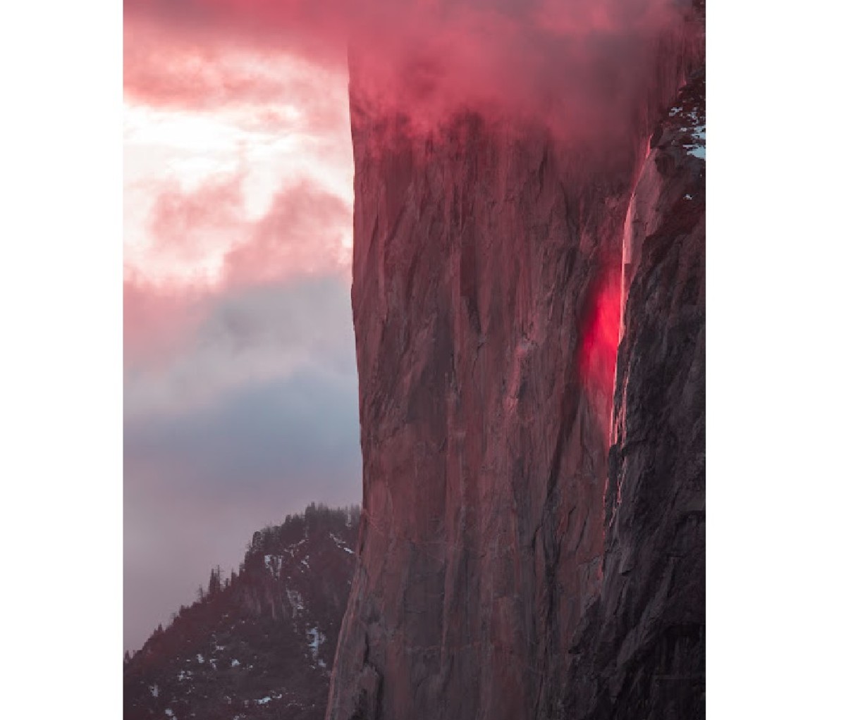 Sunset on Yosemite's El Capitan cliff with Horsetail Falls glowing red from reflected sunlight
