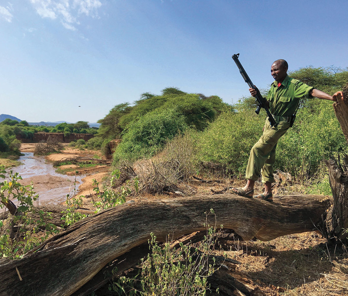 Kenyan tracker with rifle