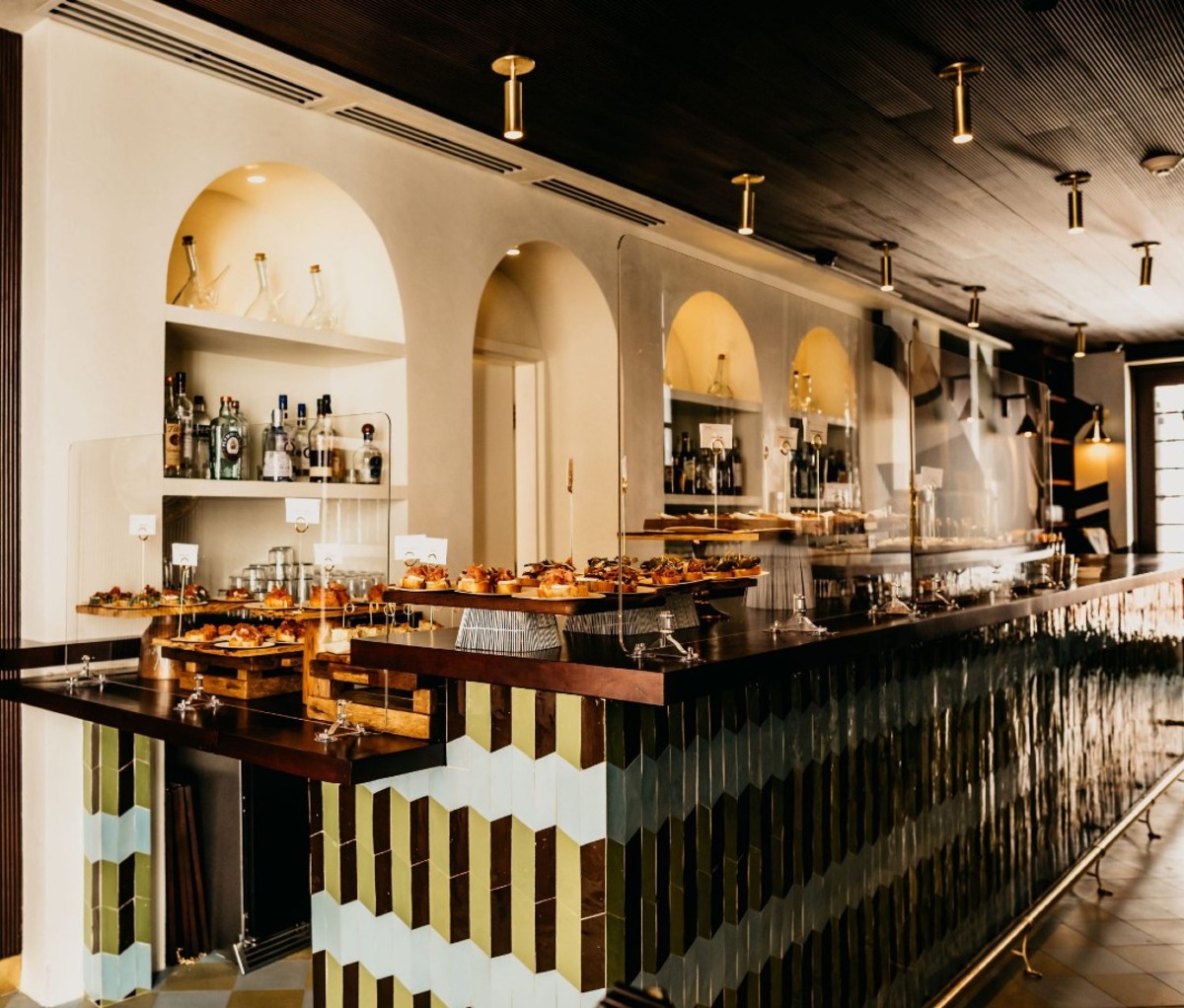 Tiled bar with tapas behind glass