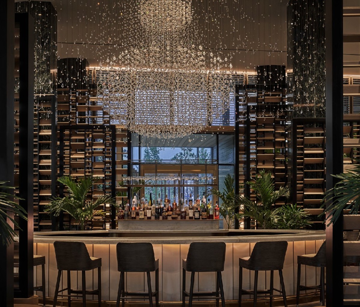 Row of chairs facing the bar and window at Chandelier Bar 