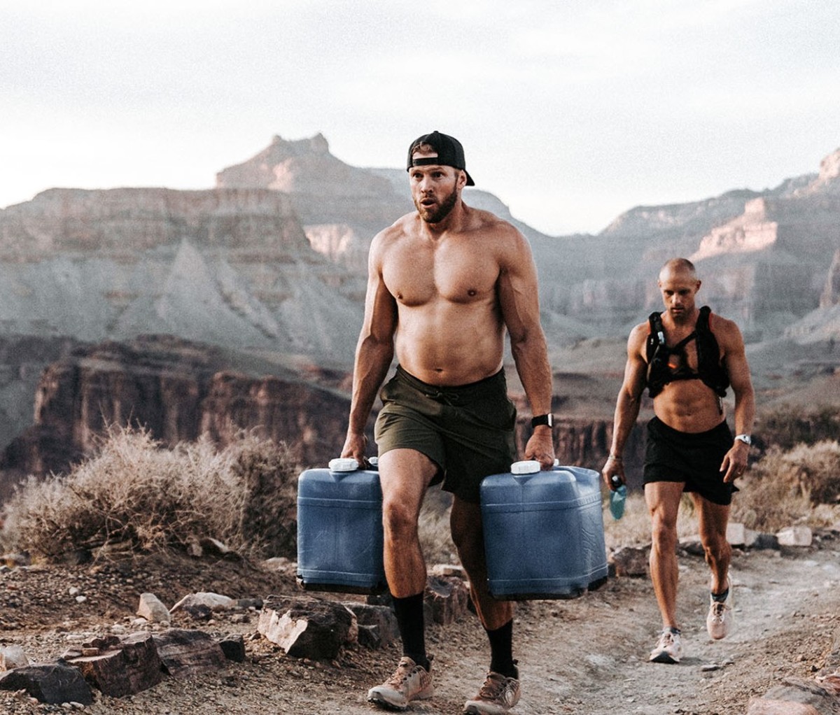 Man carries water jars up the Grand Canyon