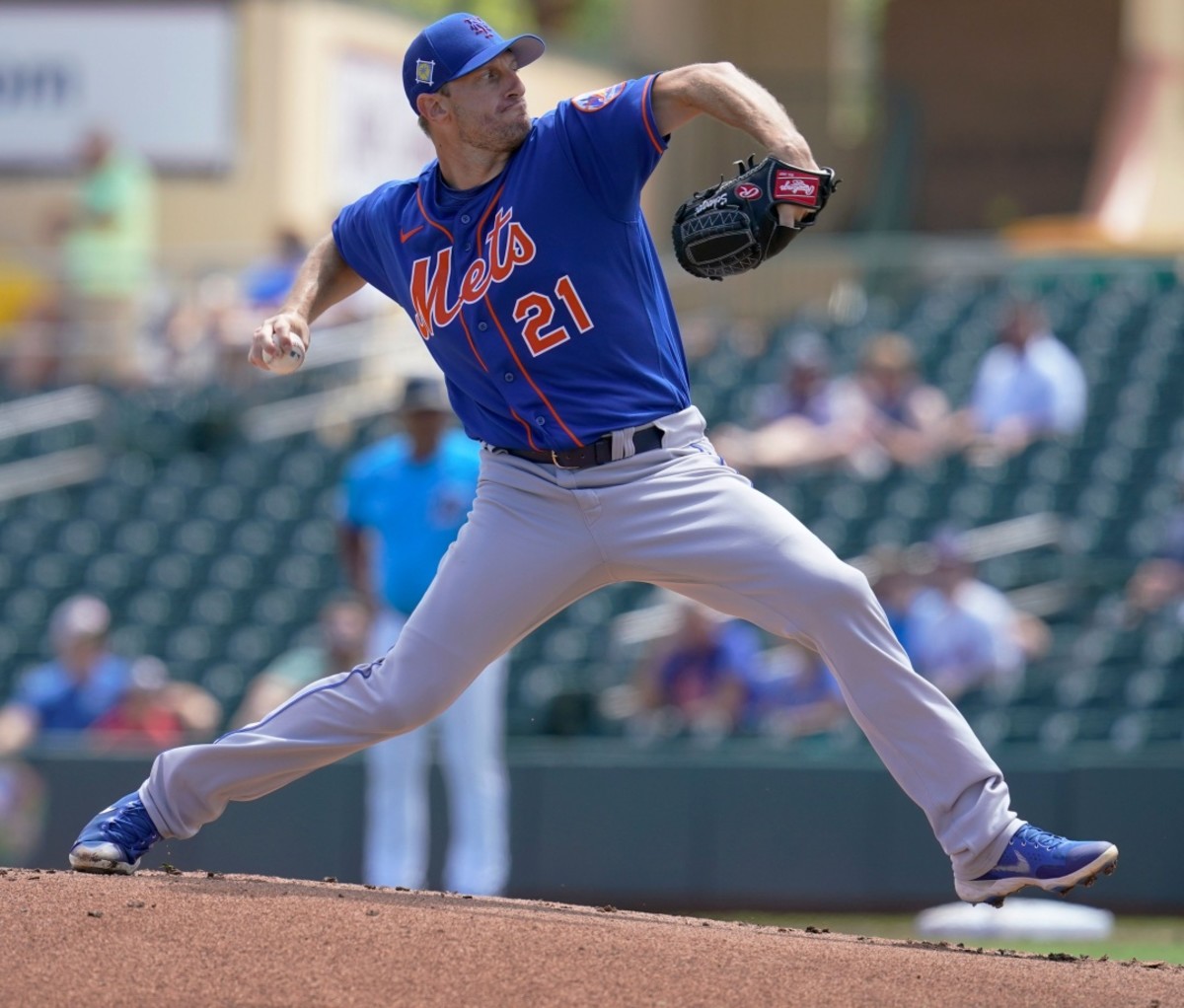 New York Mets' Max Scherzer winds up to throw a pitch during a spring training game. MLB 2022 season preview