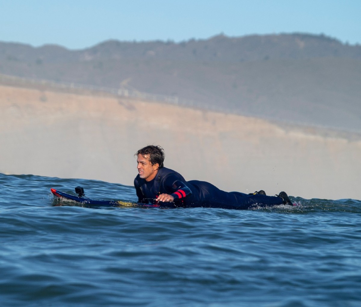 Kai Lenny float on a surfboard in the ocean