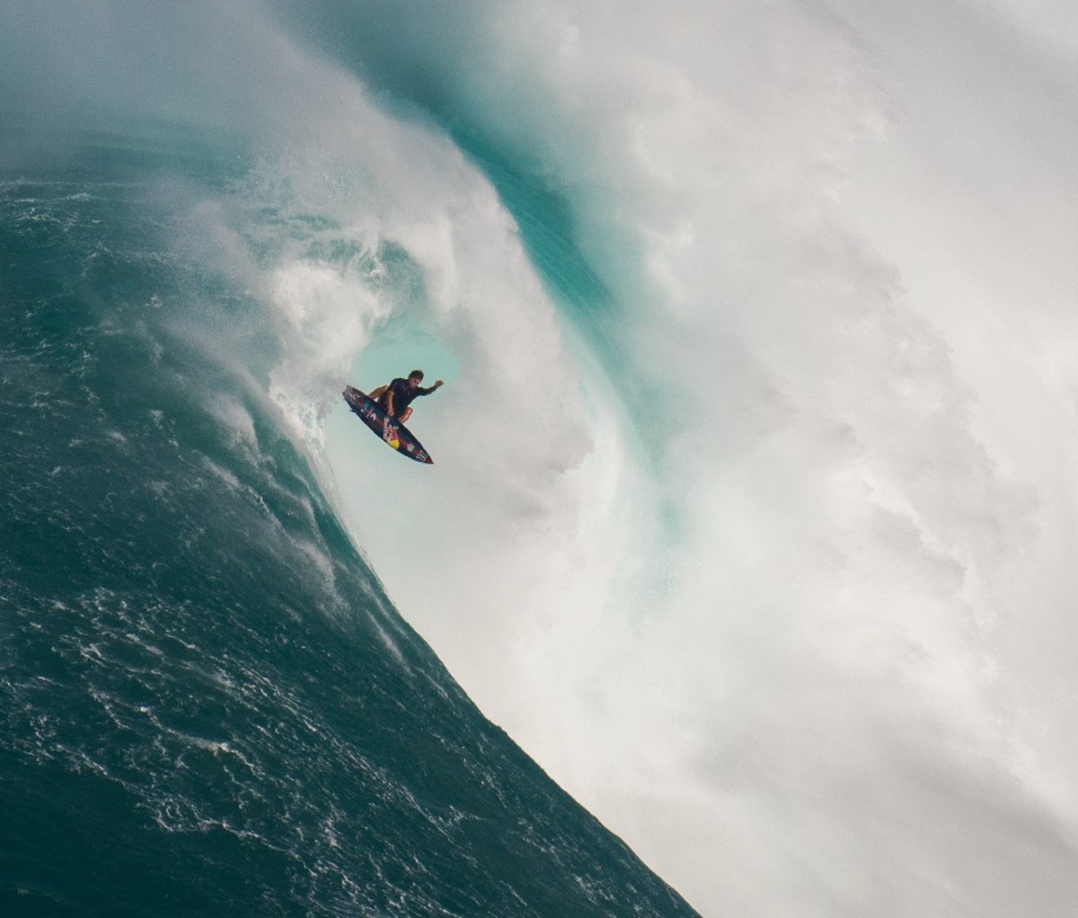Kai Lenny takes air while riding a big wave