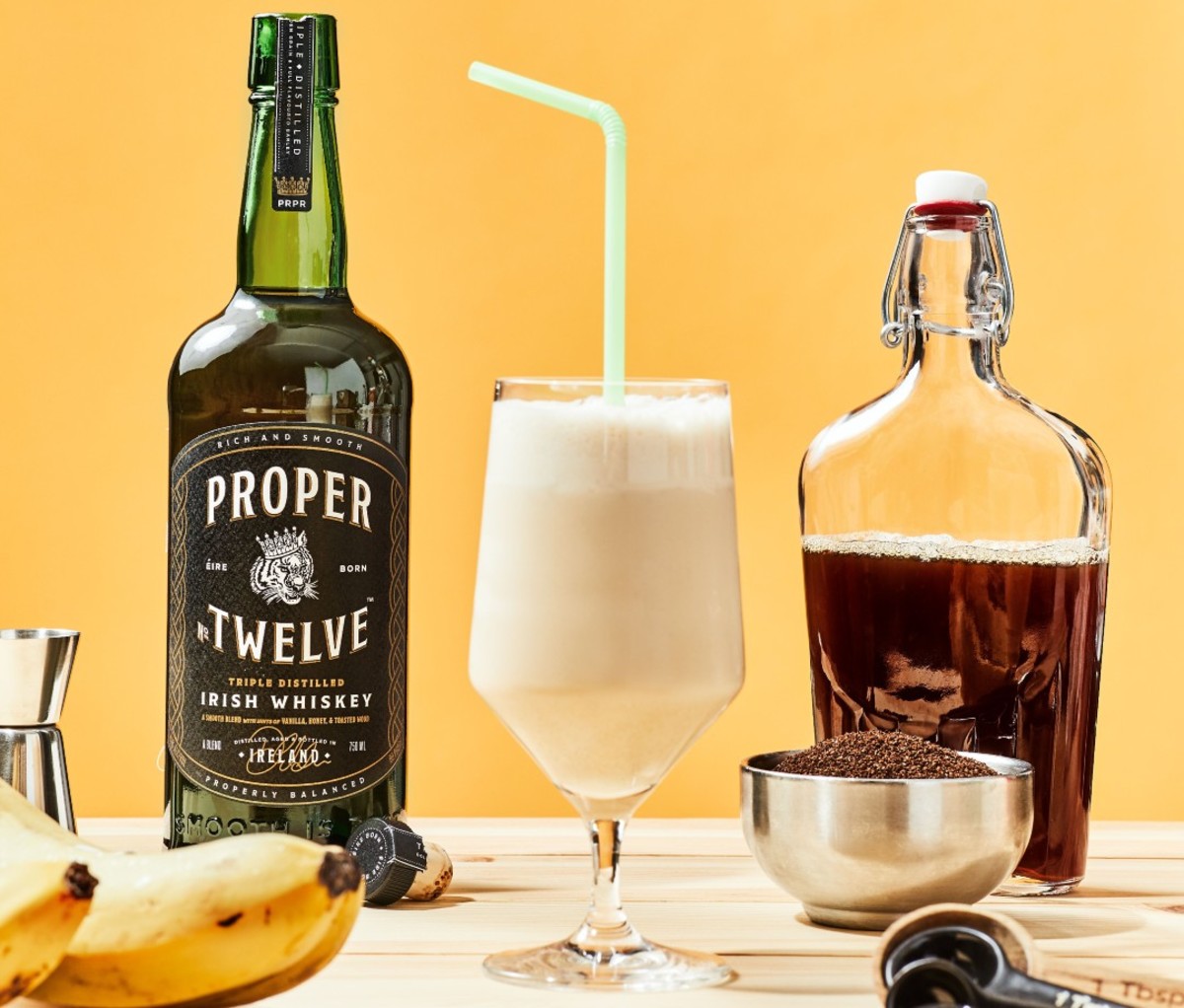 Frozen drink with bottle of whiskey and banan