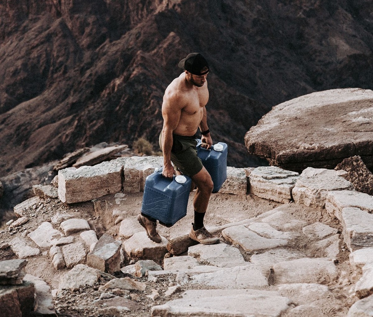 Carrying jugs of water up stone stairs