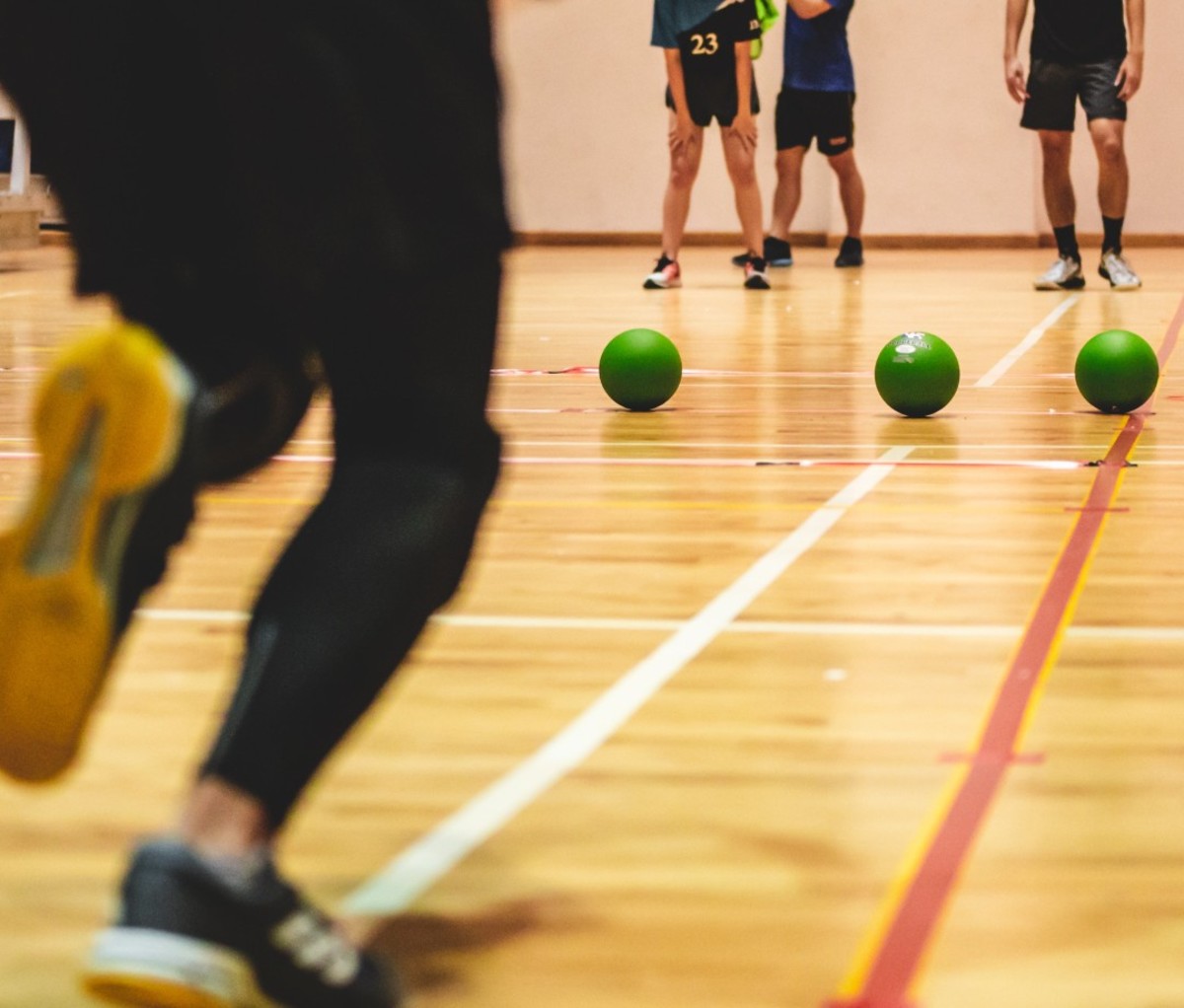 Men standing on court playing dodgeball