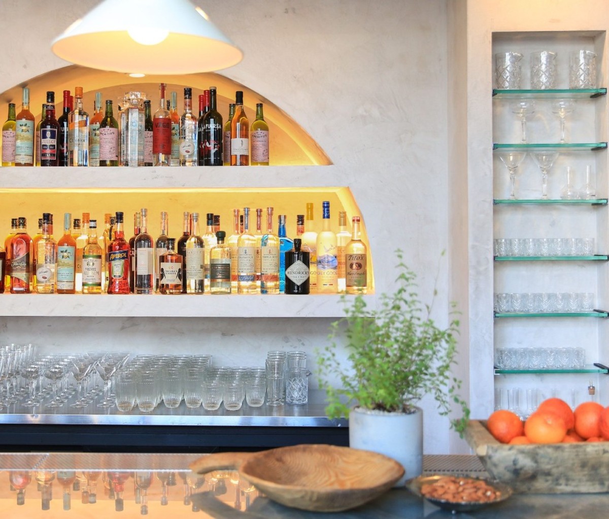 Bright arched bar with bottles on shelves