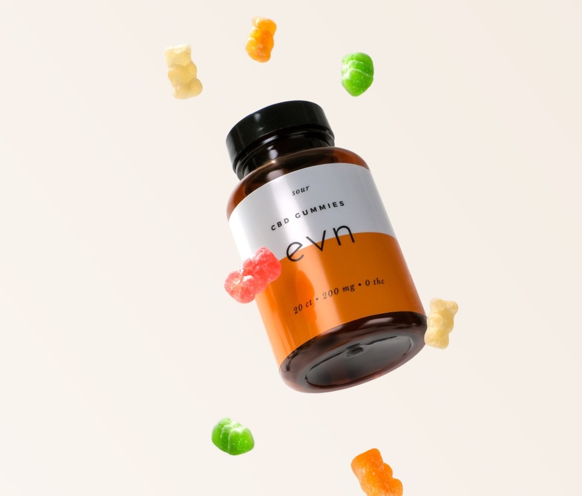 Bottle with white and orange label with colorful gummy bears flying around