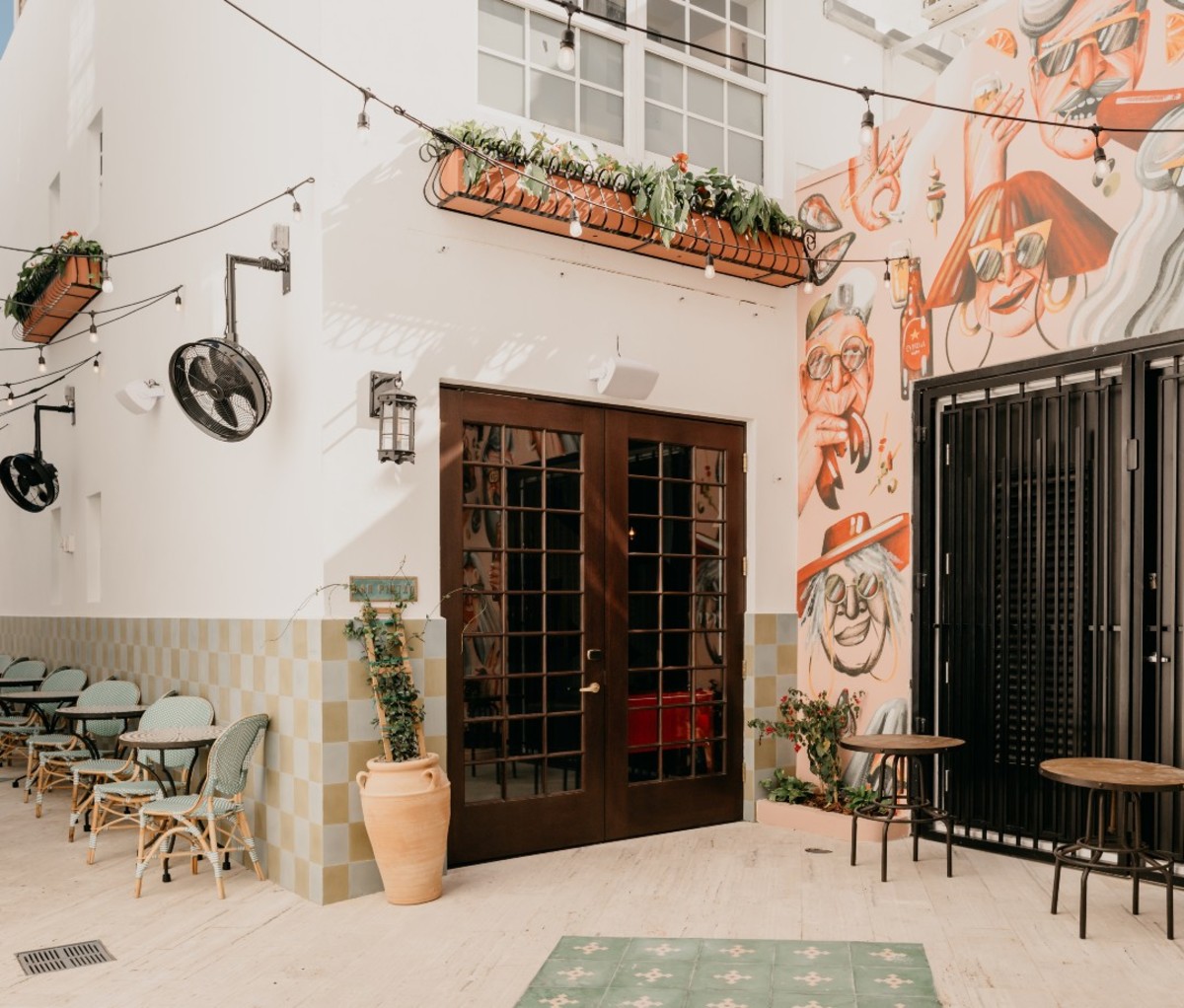 White-washed walls with tables and chairs set up in alleyway