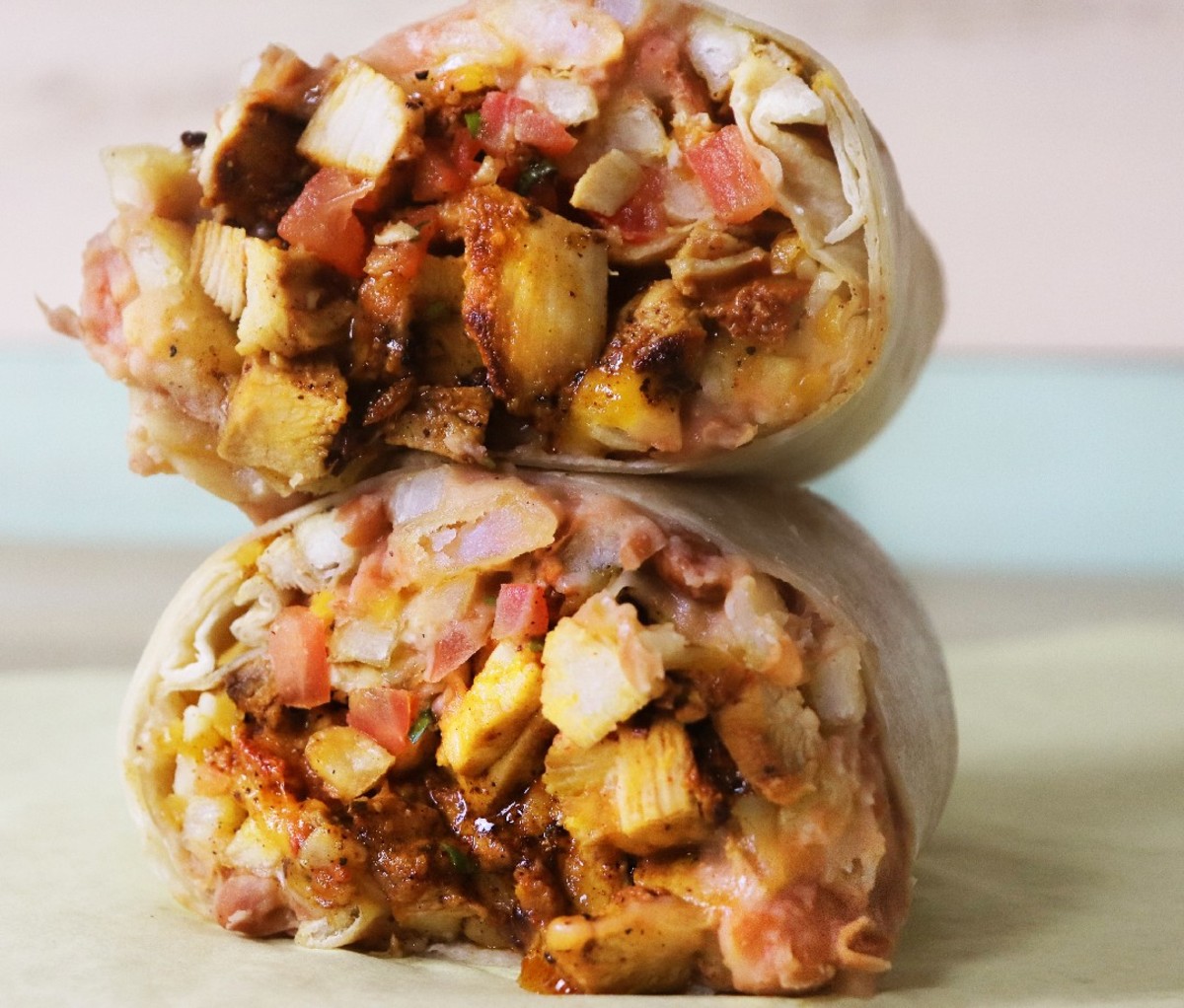 Two halves of a burrito stacked from NY's Electric Burrito