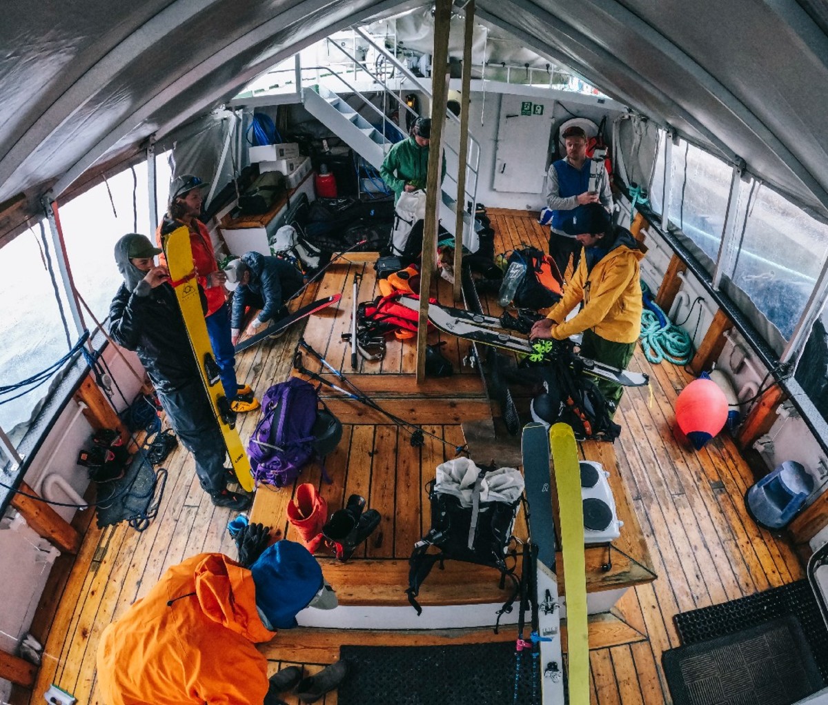 Guys gather in the boat galley preparing for a ski day.
